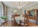 Formal dining room features tray ceiling, large windows, and hardwood flooring at 2073 Woodside Park Dr, Woodstock, GA 30188