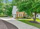 Brick home with attached garage, mature landscaping and a long driveway at 2073 Woodside Park Dr, Woodstock, GA 30188