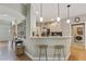 Kitchen bar with granite countertops and pendant lighting provides seating at 2073 Woodside Park Dr, Woodstock, GA 30188