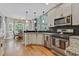 Modern kitchen with stainless steel appliances, granite countertops, and hardwood floors at 2073 Woodside Park Dr, Woodstock, GA 30188