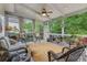 Relaxing screened-in porch with wicker furniture and a view of the lush backyard at 2073 Woodside Park Dr, Woodstock, GA 30188
