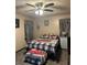 Cozy bedroom featuring a bed with vintage truck themed linens and gray window treatments at 36 Mount Tabor Rd, Covington, GA 30014