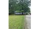 Quaint single-story home featuring a welcoming front porch and surrounded by mature trees and a spacious yard at 36 Mount Tabor Rd, Covington, GA 30014