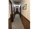 Carpeted hallway with wood-paneled wainscoting, neutral paint, and a series of doorways leading to different rooms at 36 Mount Tabor Rd, Covington, GA 30014