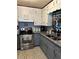 Charming kitchen with white cabinets, gray lower cabinets, stainless steel appliances, and granite countertops at 36 Mount Tabor Rd, Covington, GA 30014