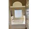 Modern bathroom with a soaking tub, tile surround, and decorative window at 3897 Valley Bluff Ln, Snellville, GA 30039