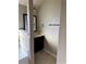 Bathroom featuring a vanity, tile flooring, and tile accent wall at 3897 Valley Bluff Ln, Snellville, GA 30039