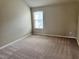 A cozy bedroom with neutral carpeting and bright natural light at 3897 Valley Bluff Ln, Snellville, GA 30039