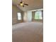 Large bonus room with carpet, ceiling fan, and plentiful natural light at 3897 Valley Bluff Ln, Snellville, GA 30039