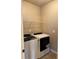 Efficient laundry area featuring modern washer and dryer units with overhead shelving for added convenience at 3897 Valley Bluff Ln, Snellville, GA 30039