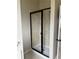A beautifully tiled shower with a sleek, black framed sliding door at 3897 Valley Bluff Ln, Snellville, GA 30039