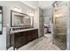 Spacious bathroom features a large vanity, walk-in shower with glass enclosure, and access to a bedroom at 635 Piping Rock Pt, Lawrenceville, GA 30043