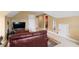 Bedroom with a brown leather sofa, large TV, and access to the bathroom at 635 Piping Rock Pt, Lawrenceville, GA 30043