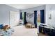 Cozy bedroom featuring light blue walls and a comfortable bed at 635 Piping Rock Pt, Lawrenceville, GA 30043