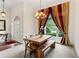 A dining area with a wooden table, bench, and a chandelier at 635 Piping Rock Pt, Lawrenceville, GA 30043