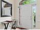 Bright entryway features a six-paneled door, hardwood floors, and transom windows at 635 Piping Rock Pt, Lawrenceville, GA 30043