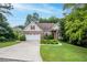 Charming brick home with a manicured lawn, mature trees, and a welcoming two-car garage at 635 Piping Rock Pt, Lawrenceville, GA 30043