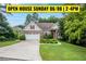 Charming brick home with a manicured lawn, mature trees, and a welcoming two-car garage at 635 Piping Rock Pt, Lawrenceville, GA 30043