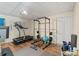 Workout room with weight rack, treadmill, and open floor space at 635 Piping Rock Pt, Lawrenceville, GA 30043