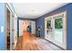 Hallway leading to pool area with glass doors and an entrance to a small kitchenette with blue cabinets at 635 Piping Rock Pt, Lawrenceville, GA 30043