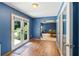 Hallway with french doors to back yard and view into a large game room at 635 Piping Rock Pt, Lawrenceville, GA 30043