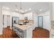 Well-lit kitchen showcasing granite countertops, an island with seating, modern appliances, and hardwood floors at 635 Piping Rock Pt, Lawrenceville, GA 30043