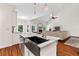 Open kitchen with stainless steel appliances, granite counters, and an island open to the living room at 635 Piping Rock Pt, Lawrenceville, GA 30043
