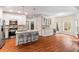 Open kitchen featuring modern appliances, a central island, and ample cabinet space with hardwood floors at 635 Piping Rock Pt, Lawrenceville, GA 30043