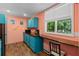 Kitchenette with blue cabinets, butcher block countertops, and window overlooking wooded backyard at 635 Piping Rock Pt, Lawrenceville, GA 30043
