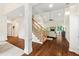 Bright, open-concept living area with hardwood floors, staircase, and neutral decor at 635 Piping Rock Pt, Lawrenceville, GA 30043