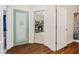 View of a pantry with a decorative glass door adjacent to a hallway with two additional doors at 635 Piping Rock Pt, Lawrenceville, GA 30043