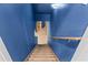 Staircase with blue walls and wood trim at 635 Piping Rock Pt, Lawrenceville, GA 30043