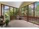 Cozy sunroom with multiple windows, neutral decor, and plenty of natural light at 635 Piping Rock Pt, Lawrenceville, GA 30043