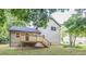 Home exterior showing a backyard, new wooden deck, green grass, and the home's siding at 1111 Fieldgate Nw Rd, Lilburn, GA 30044