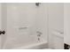 A clean white bathroom includes a tub and shower with a toilet at 1111 Fieldgate Rd, Lawrenceville, GA 30044