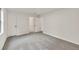 Spacious bedroom with neutral carpet, bright white walls, and entry to the bathroom at 1111 Fieldgate Rd, Lawrenceville, GA 30044