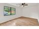 A sunny bedroom featuring sleek hardwood floors and a large window at 1111 Fieldgate Rd, Lawrenceville, GA 30044