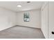 A cozy bedroom featuring soft, neutral carpet, a window, and a convenient closet at 1111 Fieldgate Rd, Lawrenceville, GA 30044