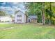 Two-story home showcasing a symmetrical design, complemented by neat landscaping and a stone porch at 1111 Fieldgate Rd, Lawrenceville, GA 30044