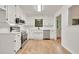 Updated kitchen featuring white cabinets, stainless steel appliances, granite counters, and hardwood flooring at 1111 Fieldgate Rd, Lawrenceville, GA 30044