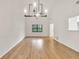 Bright living room with vaulted ceilings, modern chandelier, hardwood floors, and view to the outdoors at 1111 Fieldgate Rd, Lawrenceville, GA 30044