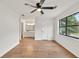 A spacious main bedroom with hardwood floors, ceiling fan, and an adjacent bathroom at 1111 Fieldgate Rd, Lawrenceville, GA 30044