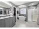 Bathroom with double vanity sinks, large soaking tub, and glass door shower at 143 Monarch Way, Hiram, GA 30141