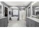 Elegant bathroom featuring double vanities, soaking tub, chandelier, and a glass door shower at 143 Monarch Way, Hiram, GA 30141