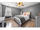 Cozy bedroom with a vanity, hardwood floors, neutral walls, and a ceiling fan at 143 Monarch Way, Hiram, GA 30141