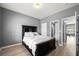 Comfortable bedroom with a large bed, wood floors, neutral walls, and natural light at 143 Monarch Way, Hiram, GA 30141
