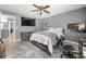 Bedroom features a hardwood floor, queen bed, and television at 143 Monarch Way, Hiram, GA 30141