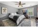 Bedroom with a ceiling fan, hardwood floors, and movie posters on the wall at 143 Monarch Way, Hiram, GA 30141
