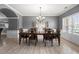 Elegant dining room with wood floors, chandelier, and large window at 143 Monarch Way, Hiram, GA 30141