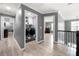Hallway with hardwood floors that lead to the laundry room, bedroom, and stairs at 143 Monarch Way, Hiram, GA 30141